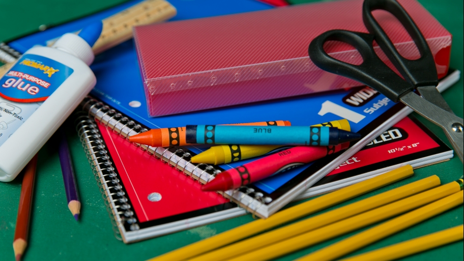 School supplies including glue, pencils, crayons and scissors